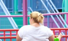 Junge Frau mit starkem Übergewicht (Adipositas) in einem Park